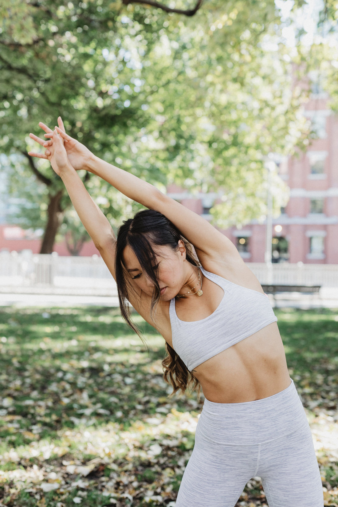 Woman stretching outdoors representing calm and focus; illustrates natural supplements and adaptogens for stress relief and energy.